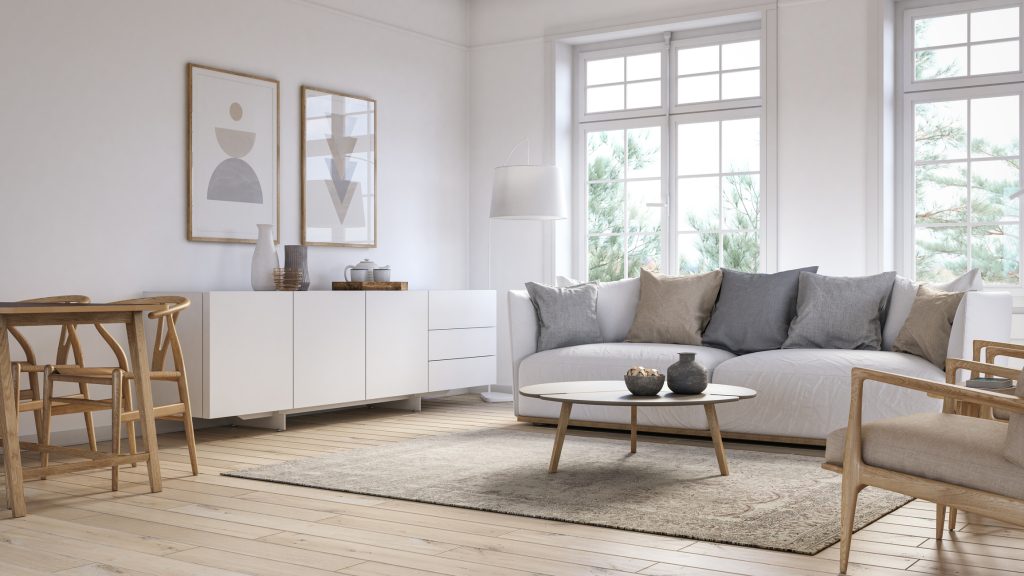 Living room with white colored furniture, a rug, and wooden elements.