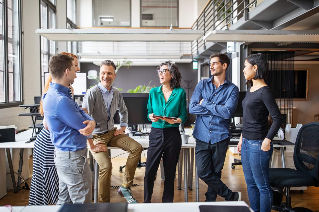 happy business colleagues talking together in office