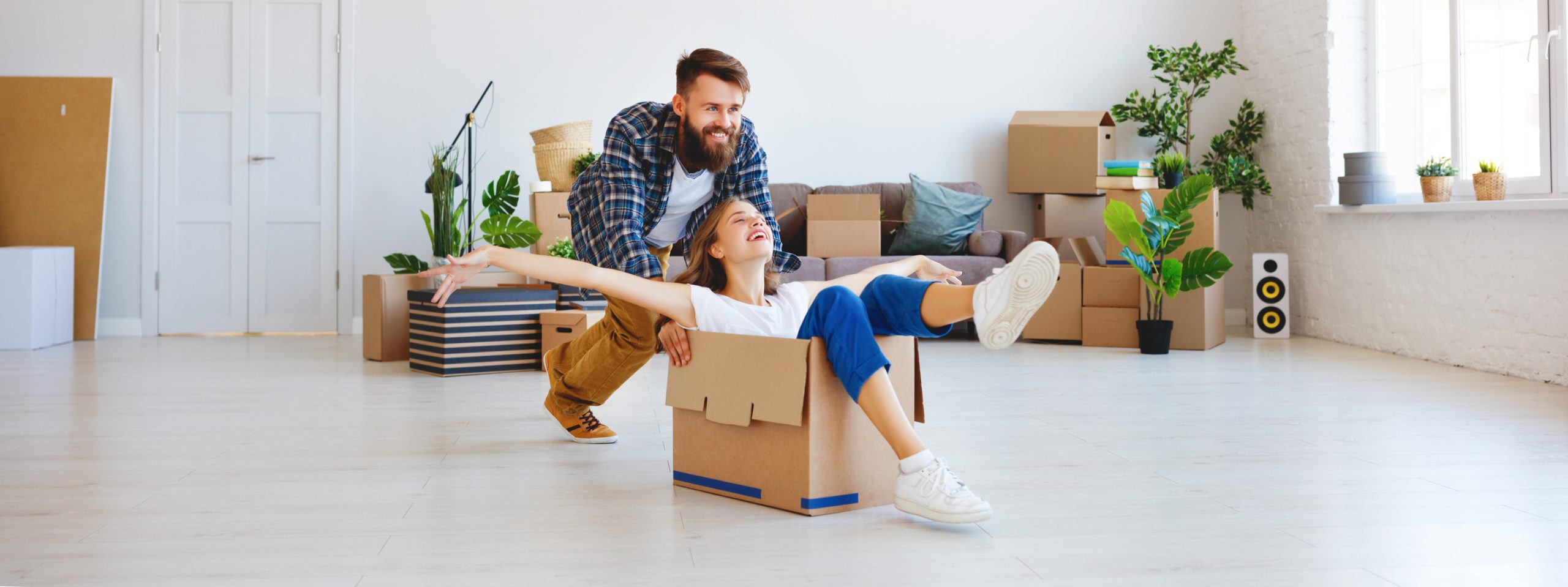 a happy young married couple moves to new apartment