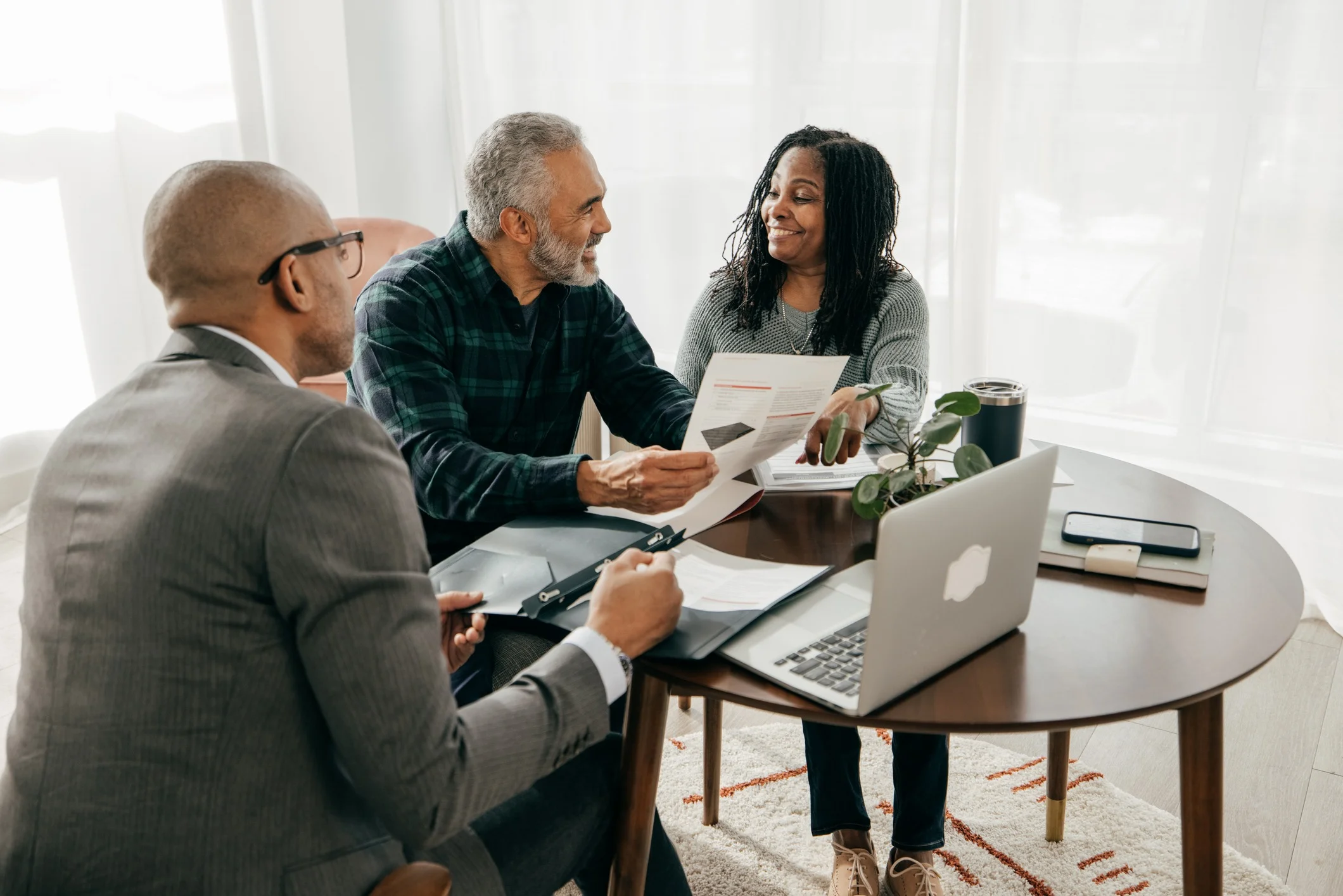 A couple is speaking with their loan officer during their year-end mortgage review.
